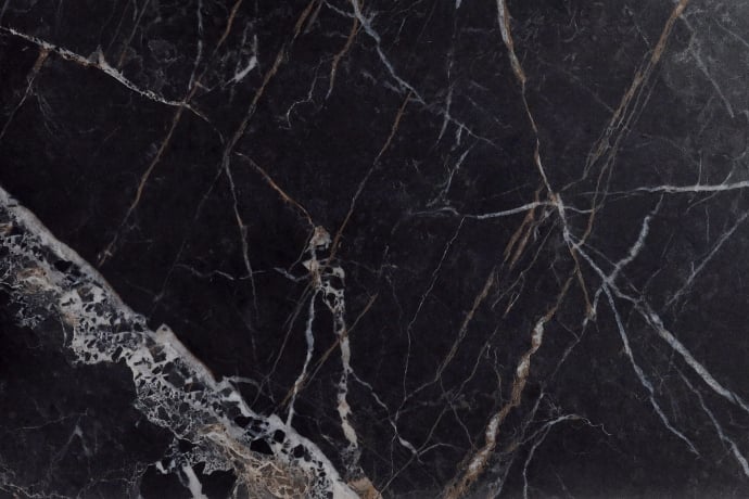 Matt black marble with golden and white veins